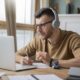 young-man-studying-library-using-laptop-1